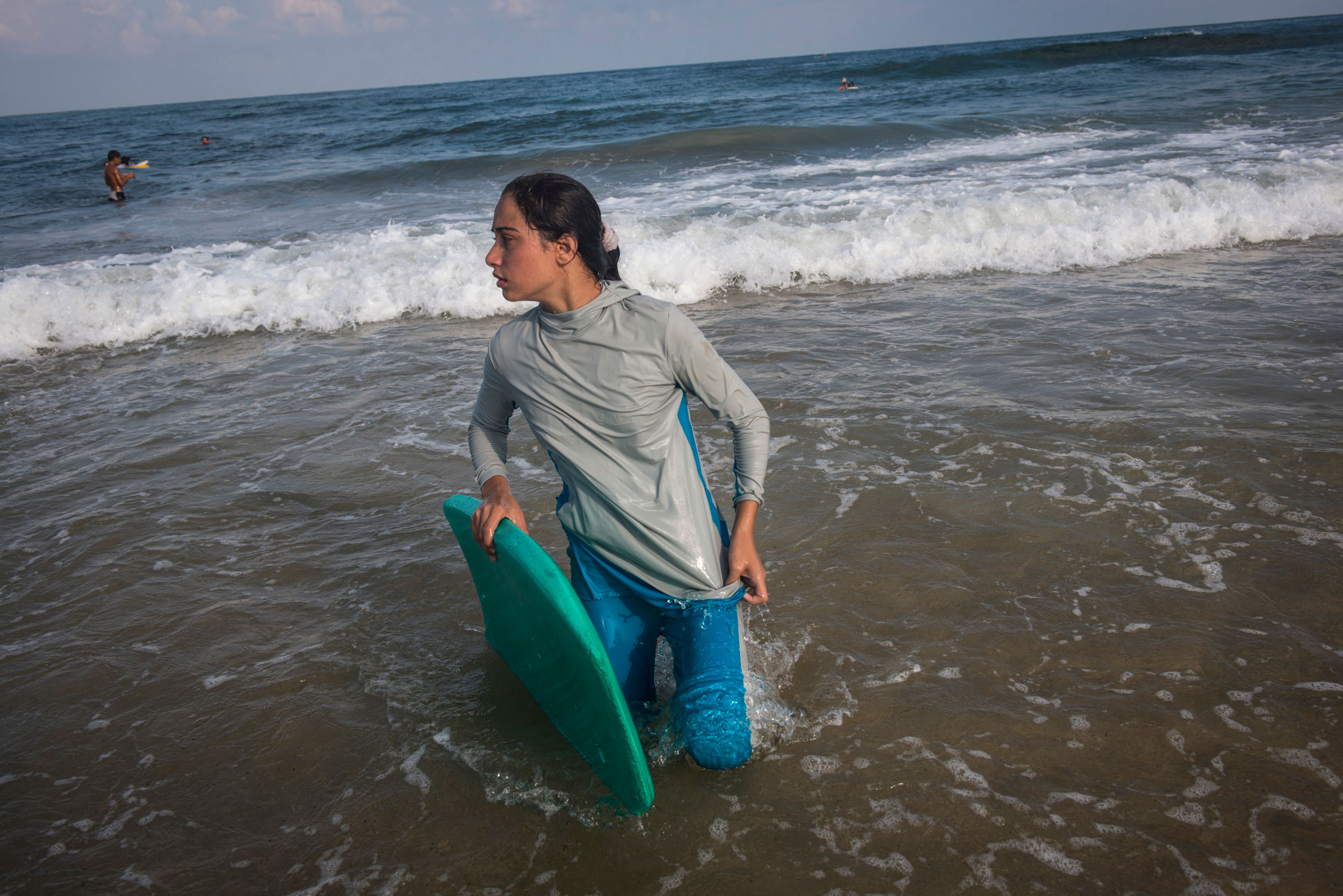 For many Gazans, the sea is the only place they can be without being reminded of their isolation. Female Surfer, Sabah Abu Ghanem,14, and her sister surf early in the morning outside of Gaza city. The sisters place first in many competitions inside 