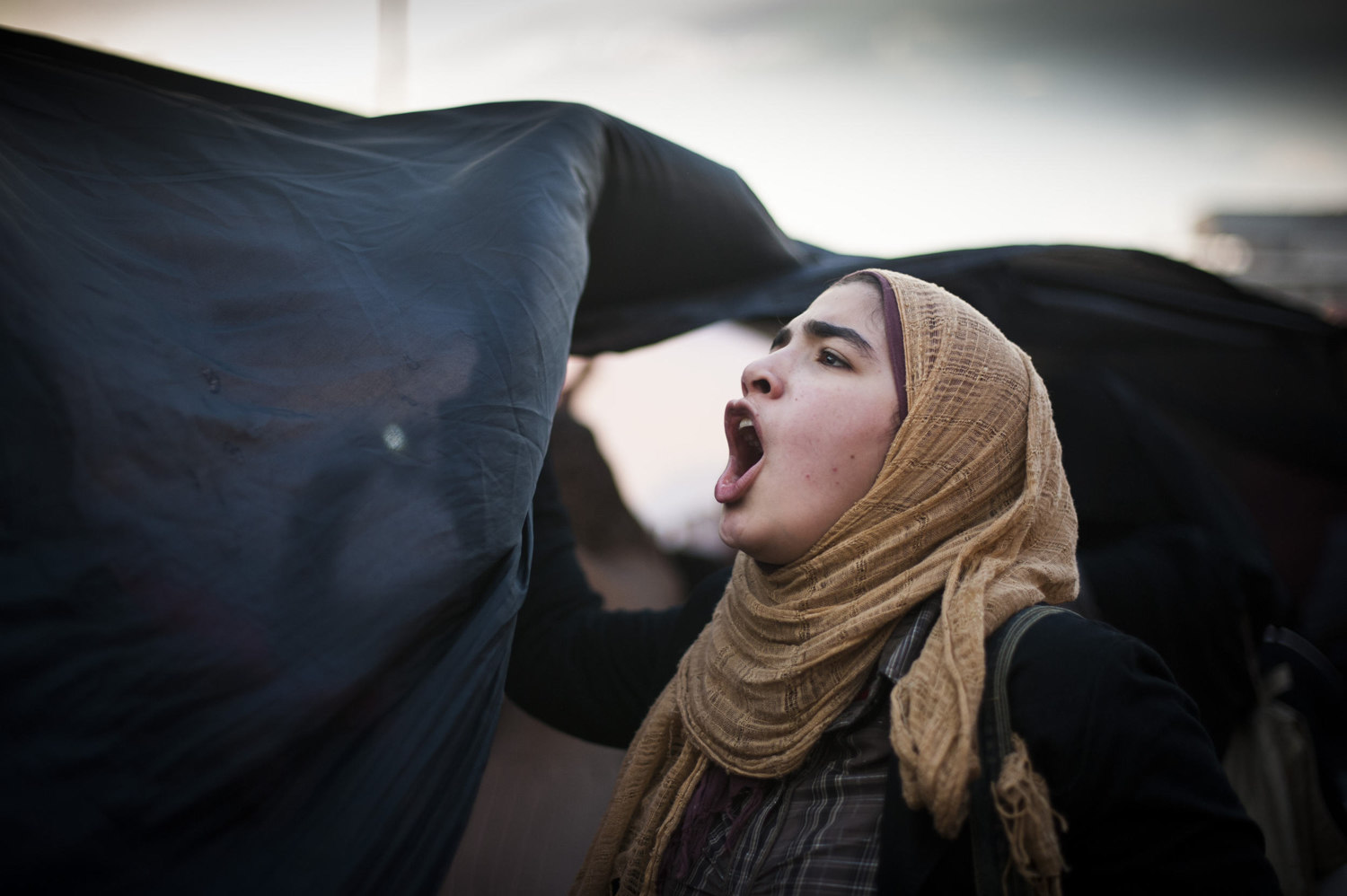  A girl holds the side of an Egyptian flag during a protest in Tahrir Square on February 8, 2011. 