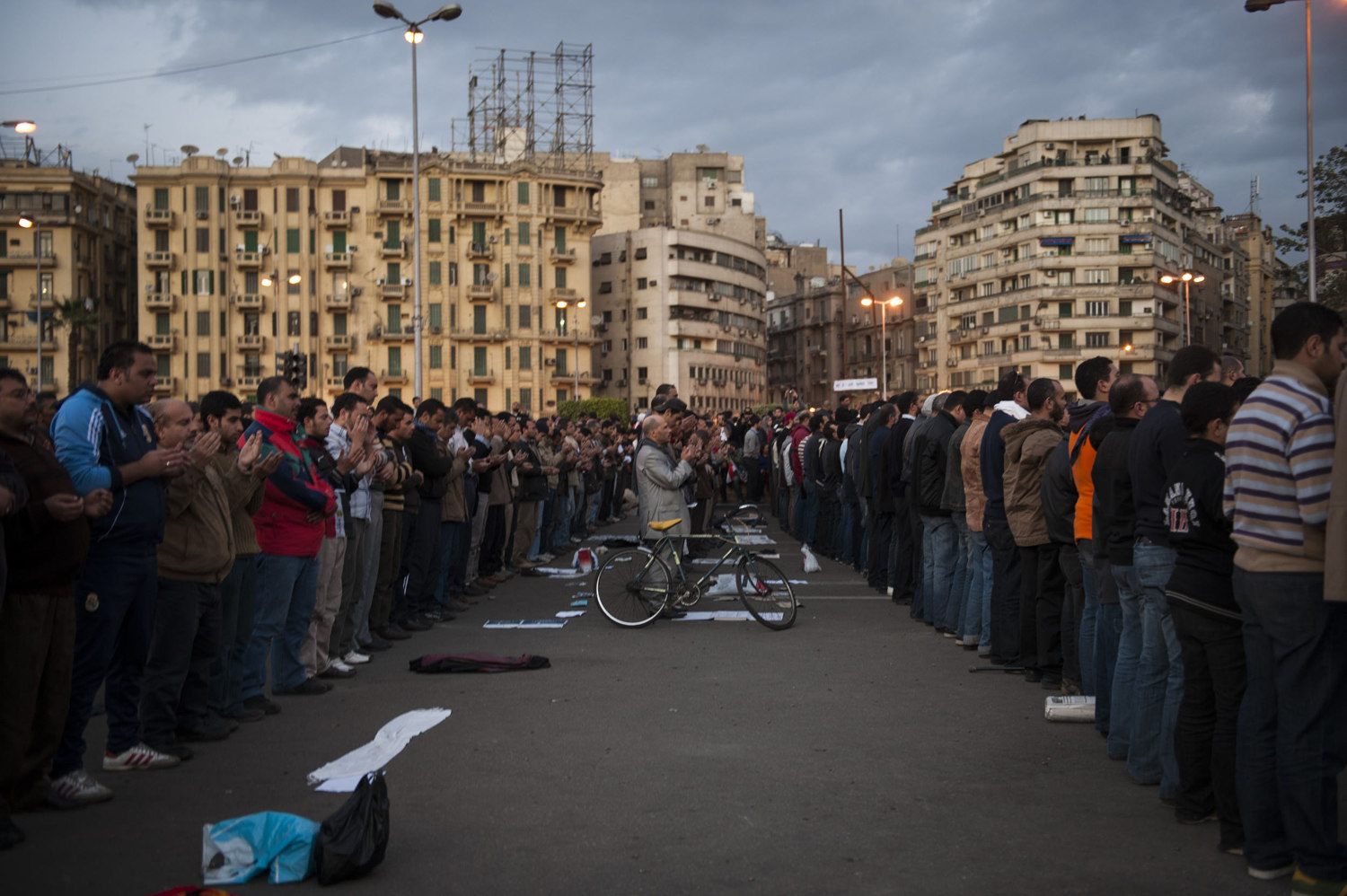  Demonstrators pray during the evening as a peaceful protest against the Mubarak regime in Tahrir Square. 