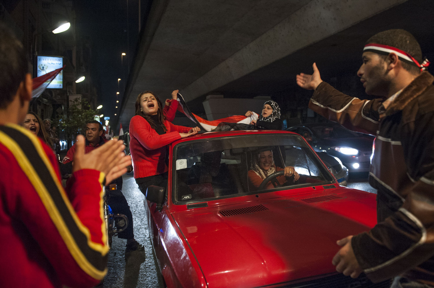  A car full of women and Egyptians celebrate under the 16th of July bridge in Zamalek, Cairo after President Mubarak announced his resignation on February 11,2011 resulting in the success of eighteen days of protest. 