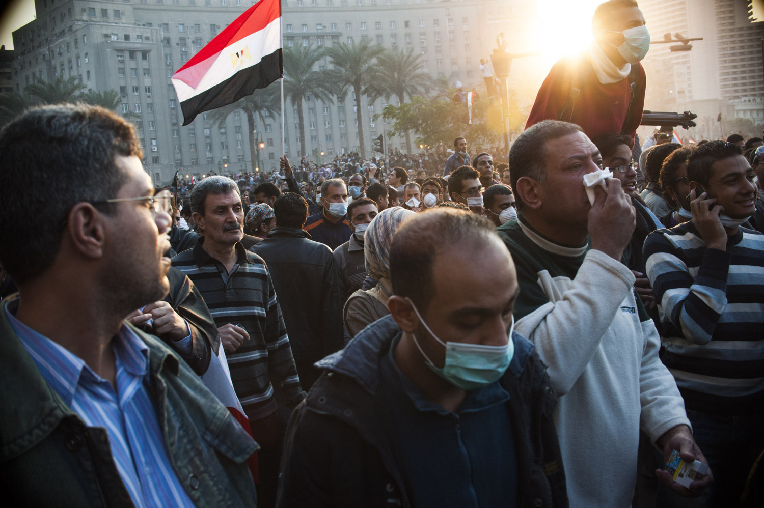  Onlookers in Tahrir Square watch Protestors come out of Mohamed Mahmoud Street where the Egyptian riot police fire tear gas into the crowd. on November 22nd 2011. 