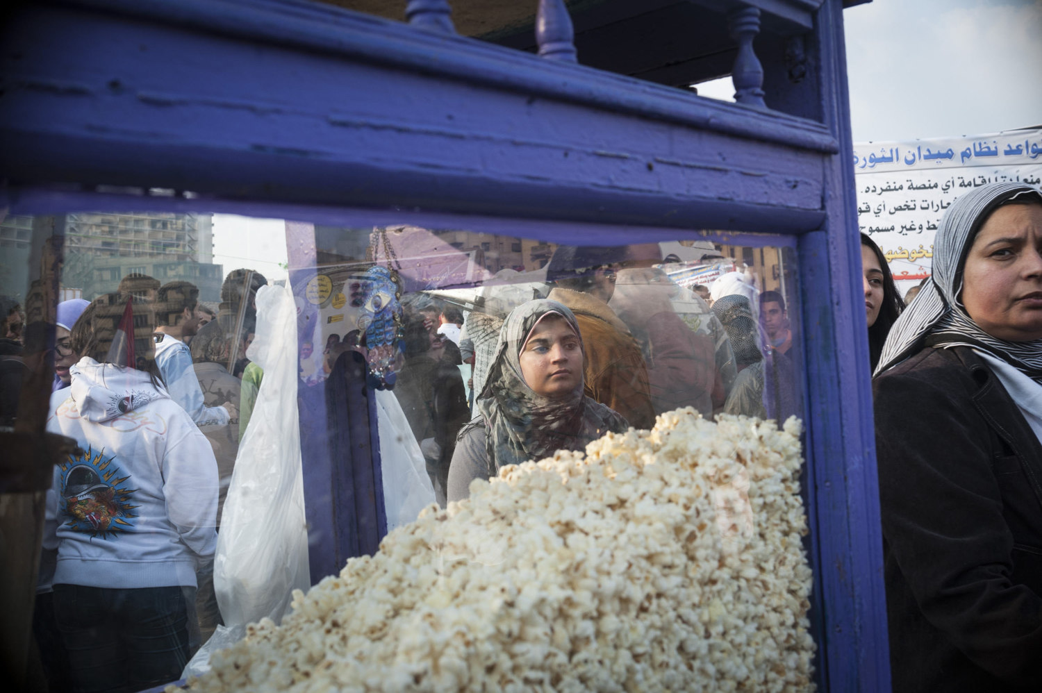 A girl stands near a popcorn vendor in Tahrir Square on November 25th, 2011. 