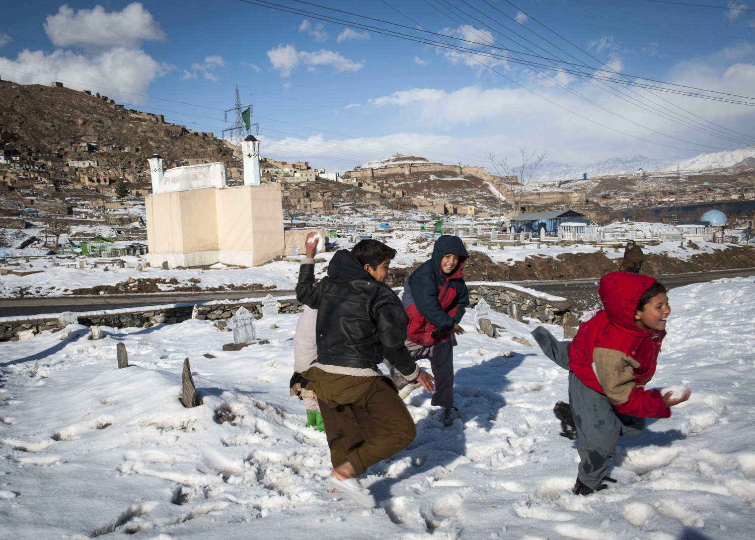  Kabul children, off for winter vacation play in the snow of the Shohadaie Saliheen Cemetery of Kabul, Afghanistan. Interestingly cemeteries are very social places in Afghanistan and are common for recreation. 