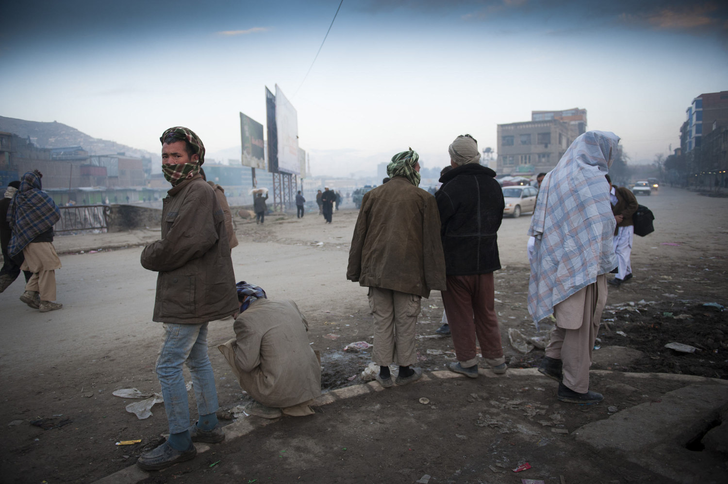  Day laborers wait outside the Pashto Market in downtown Kabul hoping to be chosen to work for the day. Workers make 250 Afghans (3-5 dollars) a day and often come from provinces in Afghanistan to seek out  the unregulated labor market and often live