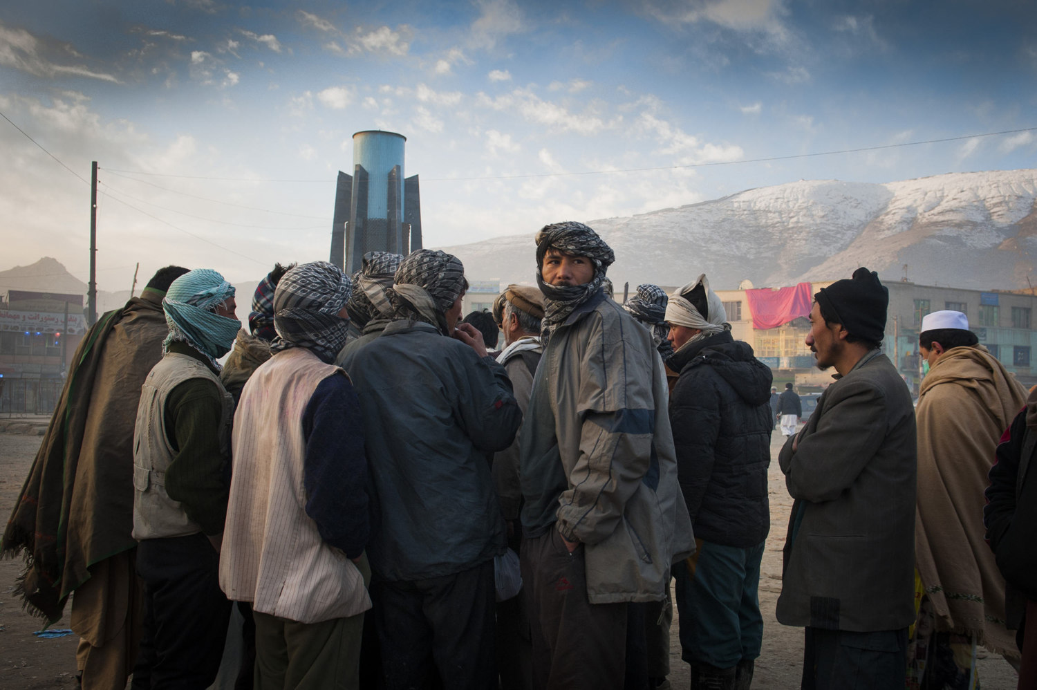  Day laborers fight for the chance to work with a contractor outside the Pashto Market in downtown Kabul hoping to be chosen to work for the day. Workers make 250 Afghans (3-5 dollars) a day and often come from provinces in Afghanistan to seek out  t