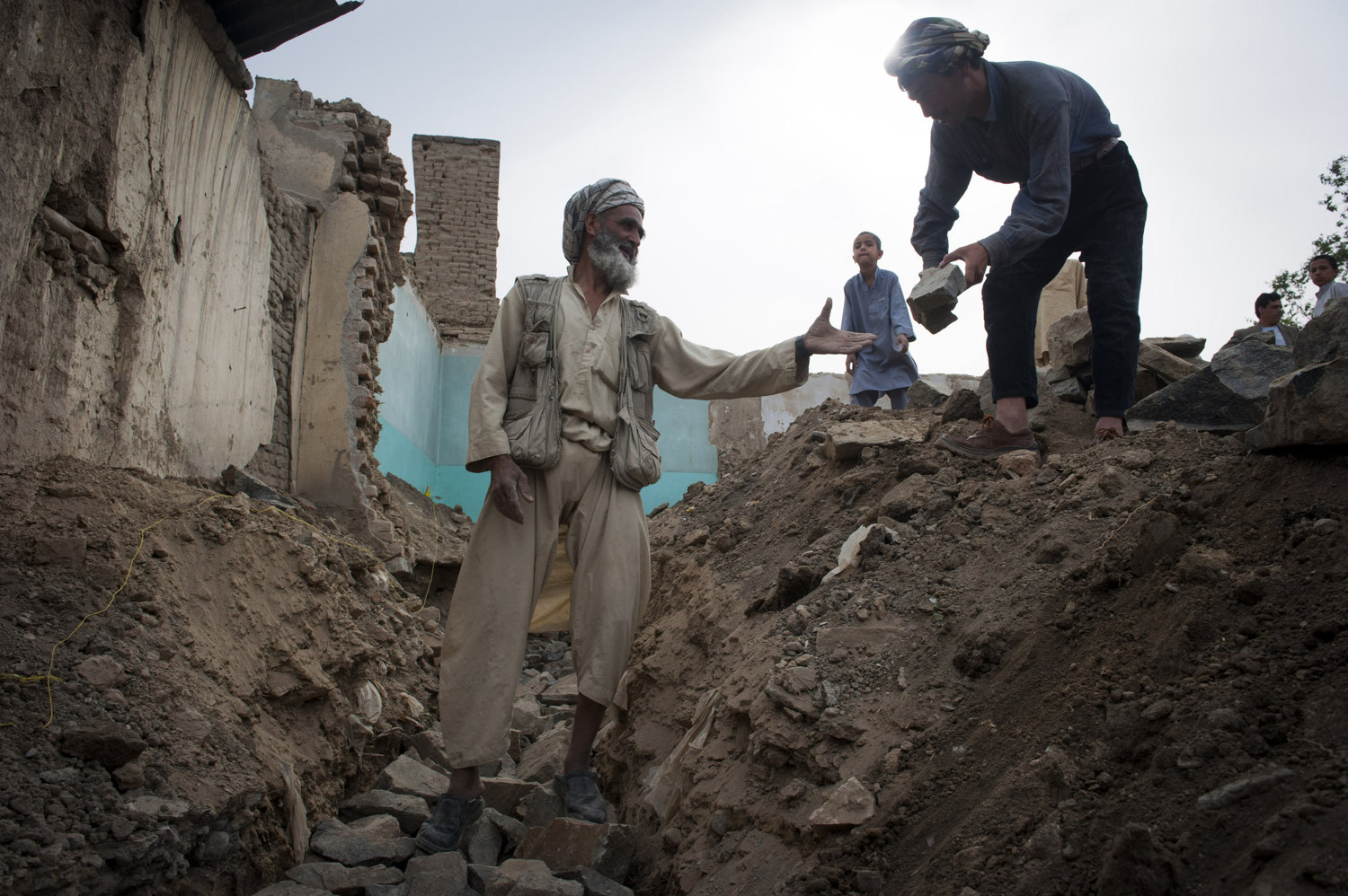  Sanangon, from Mazar Sharif lays rock in a trench that will be the foundation of the house in Kabul.The entire construction of the house will be done by unregulated labor. 