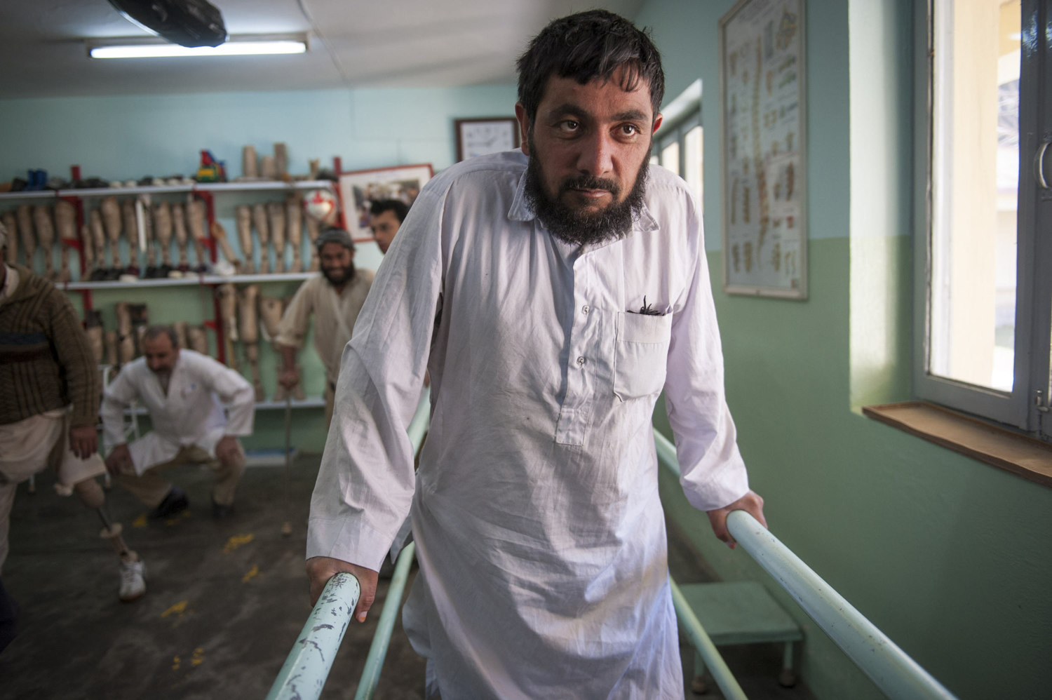  Gholom Rasol holds on to rails to assist him while walking at the International Center for the Red Cross in Herat, Afghanistan. Rasol, from Guzara outside of Herat, lost both of his legs in a what is believed to be a car bombing organized by the Tal