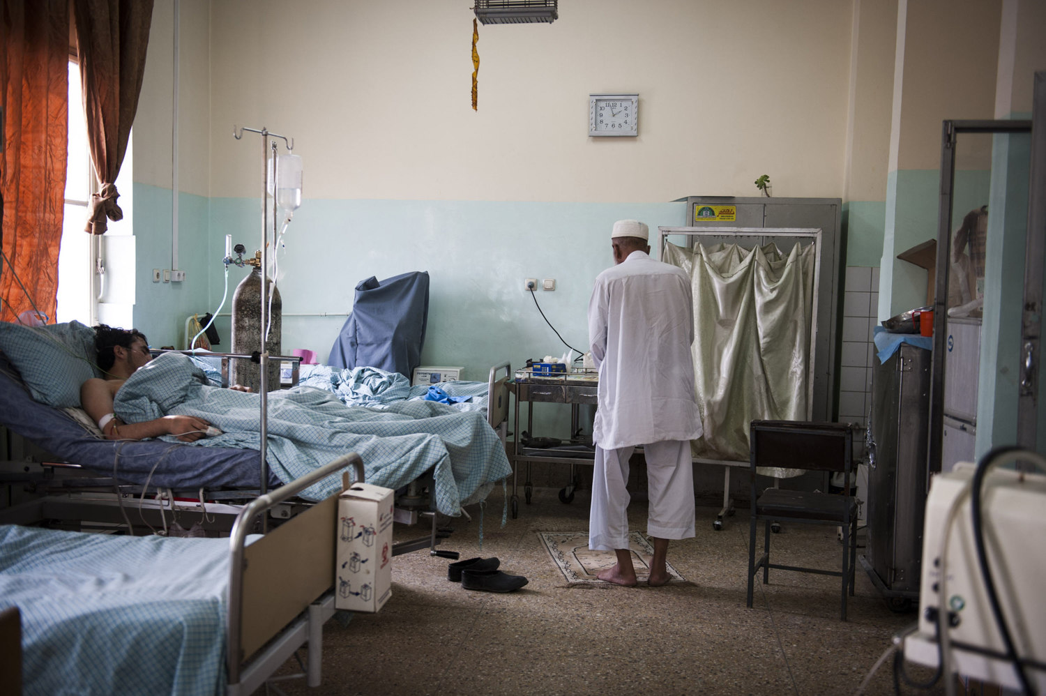  Haji Abdul Salam prays in the Mens ward of Wazir Akbar Khan Hospital. Salam recently had an operation to remove his liver stones. He traveled over 100 km from his home province of Logar, to Kabul which is the nearest hospital.  