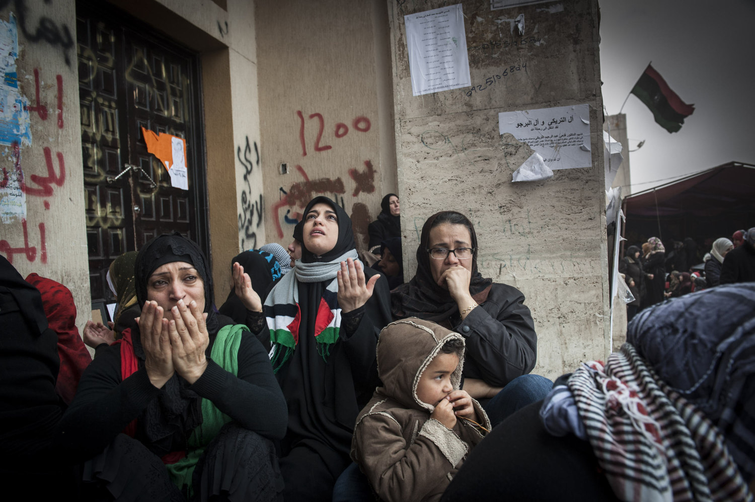  Women cry while mourning their relatives during Friday Prayers in front of  Benghazi's downtown courthouse, men and women pray for safety and for the end of Gaddafi's reign. After a violent battle, the resistance members in Benghazi overtook city an