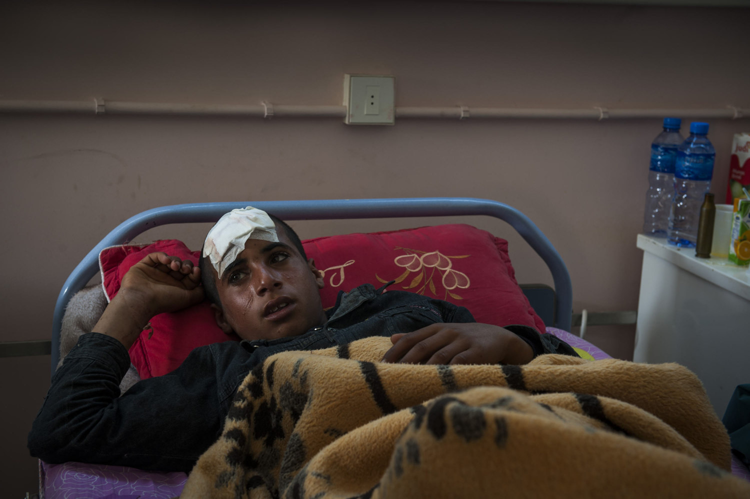  A young boy, injured yesterday in the fighting, cries as he recounts what happened to him in Brega Hospital, in Brega Libya 