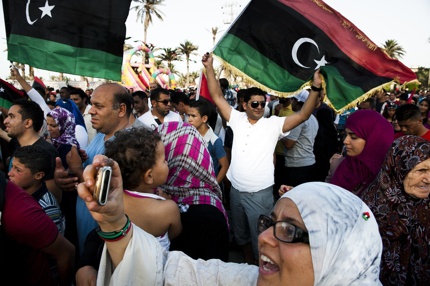  Libyans celebrate after voting. After 42 years of Muammar Gaddafi's reign, Libyans are participating in the first democratic election since 1969. Calls for boycott and election violence threatens the momentous day as campaigning drew to a close the 
