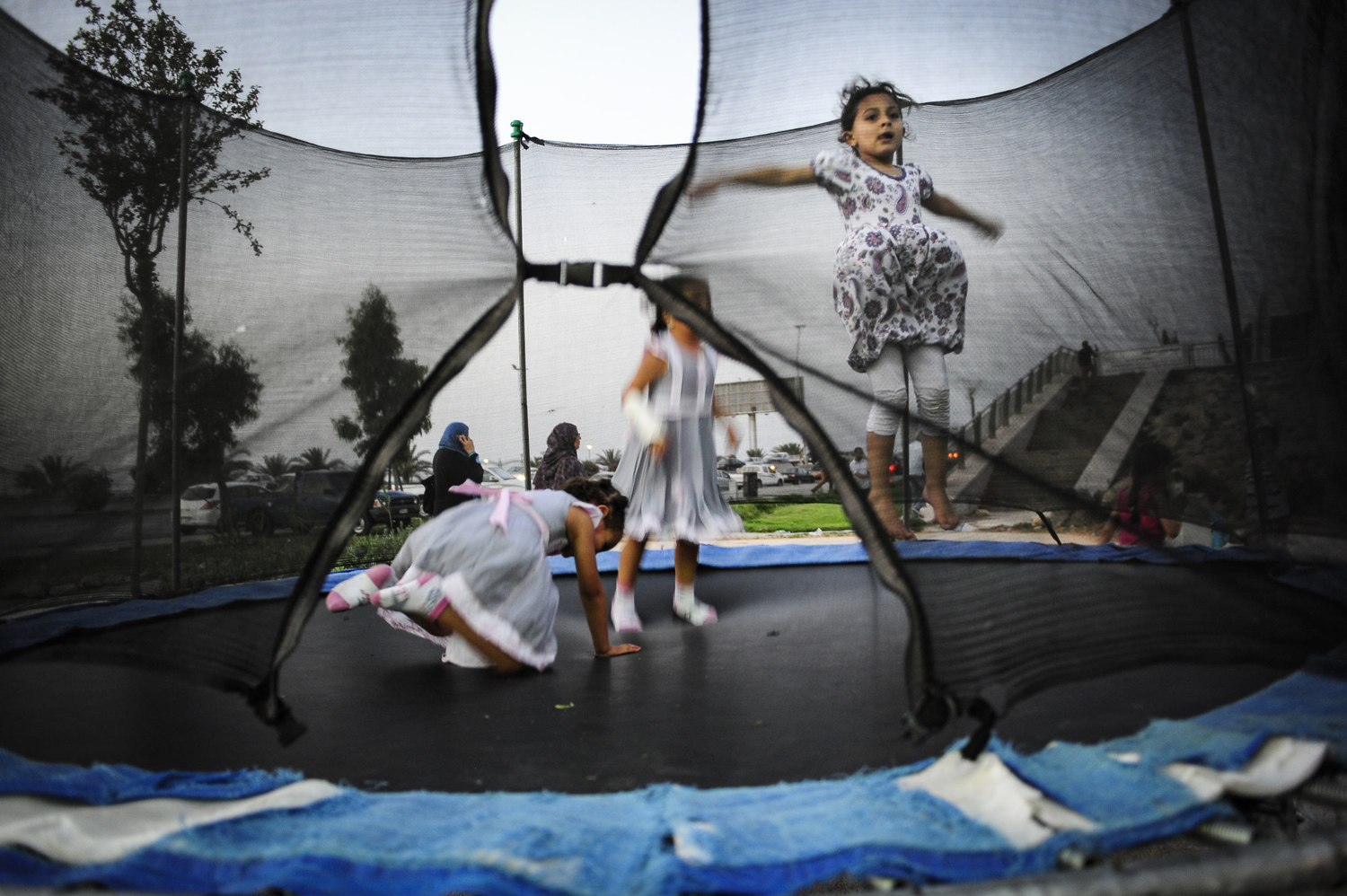  Girls jump on a trampoline in an amusement park in Tripoli, Libya. On July 6th 2012 