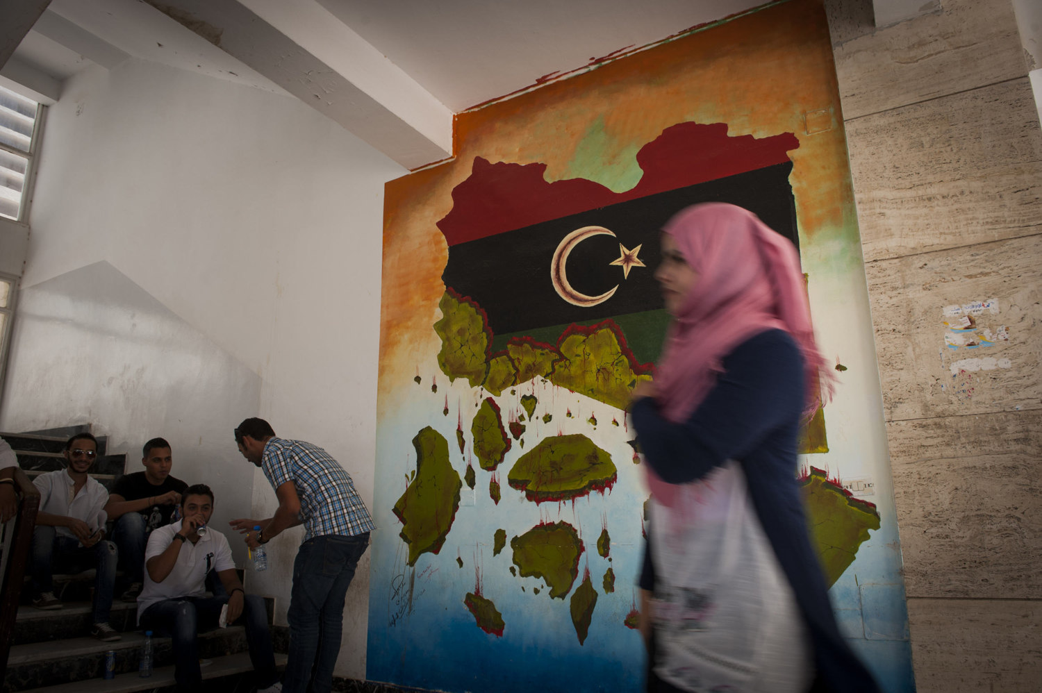  Students at Tripoli University, in front of a mural painted by Bilal and Nazih on July 12th 2012.

 