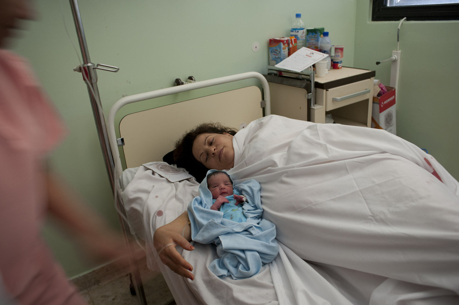  Mabroka Rajah with her newly born baby in Tripoli Medical Center. Children born after the Civil War will never know what Libya was like under Gaddafi.

 