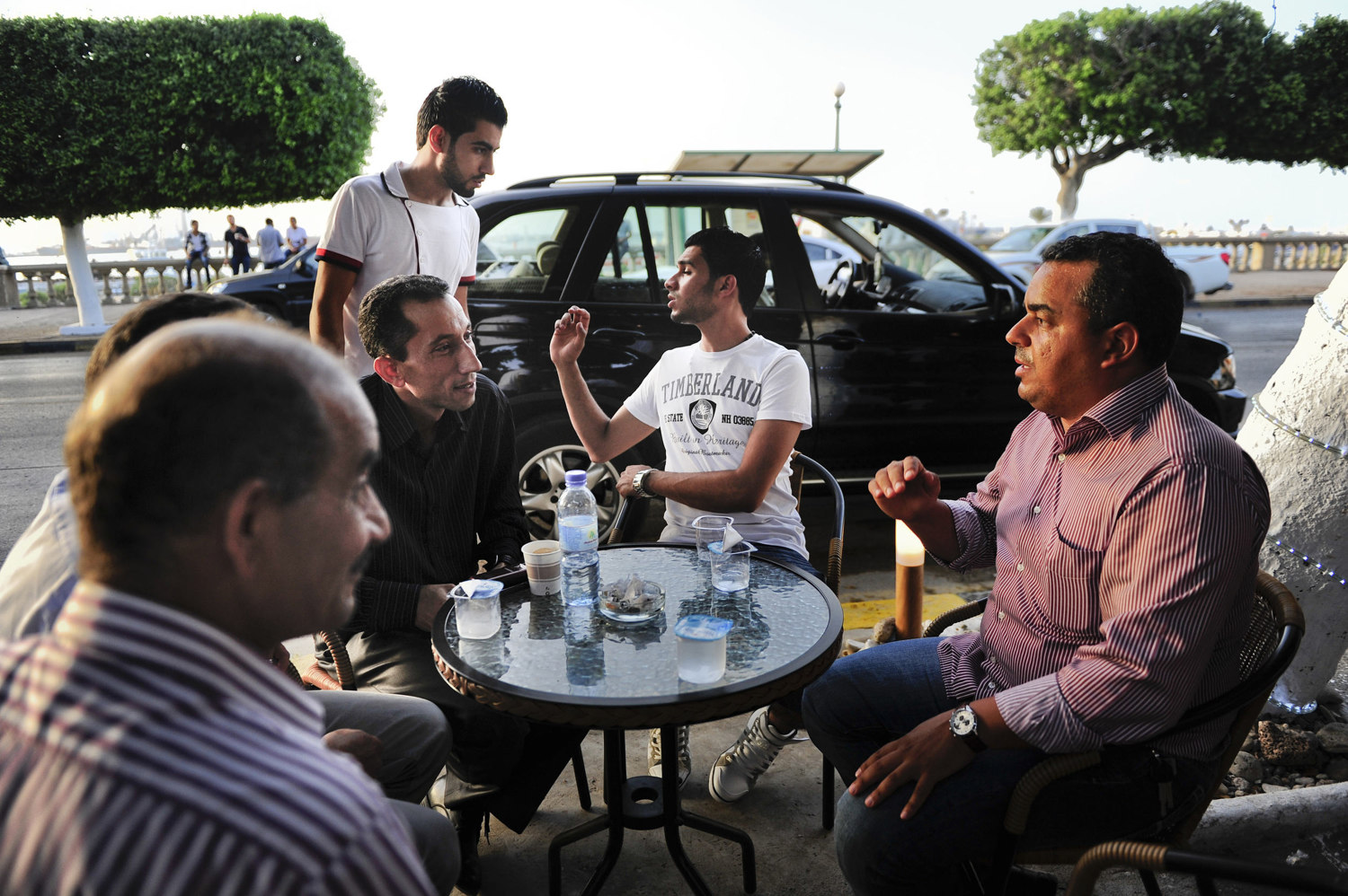  A group of men debate politics outside of a coffee house on the eve of the country's first election since the end of the Gaddafi rule,&nbsp;Calls for boycott and election violence threatens the momentous day as campaigning drew to a close the day be