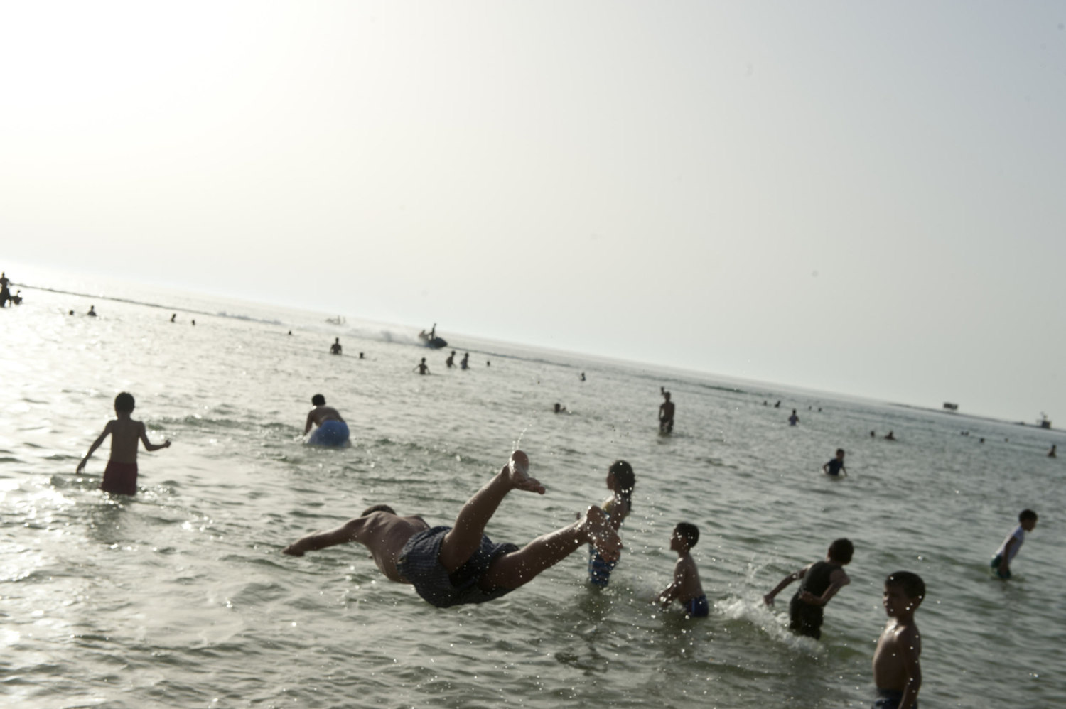  Boys escape the summer heat by diving into the ocean in downtown Tripoli on July 1st, 2012.

 