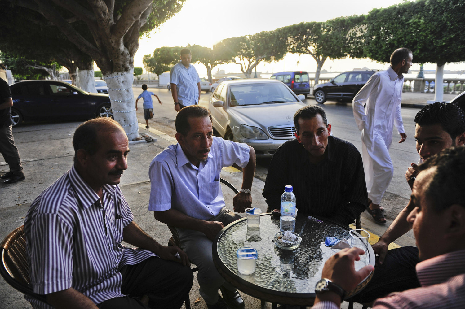  A group of men debate politics outside of a coffee house on the eve of the country's first election since the end of the Gaddafi rule, July 6th, 2012. After 42 years of Muammar Gaddafi's reign, Libyans are participating in the first democratic elect