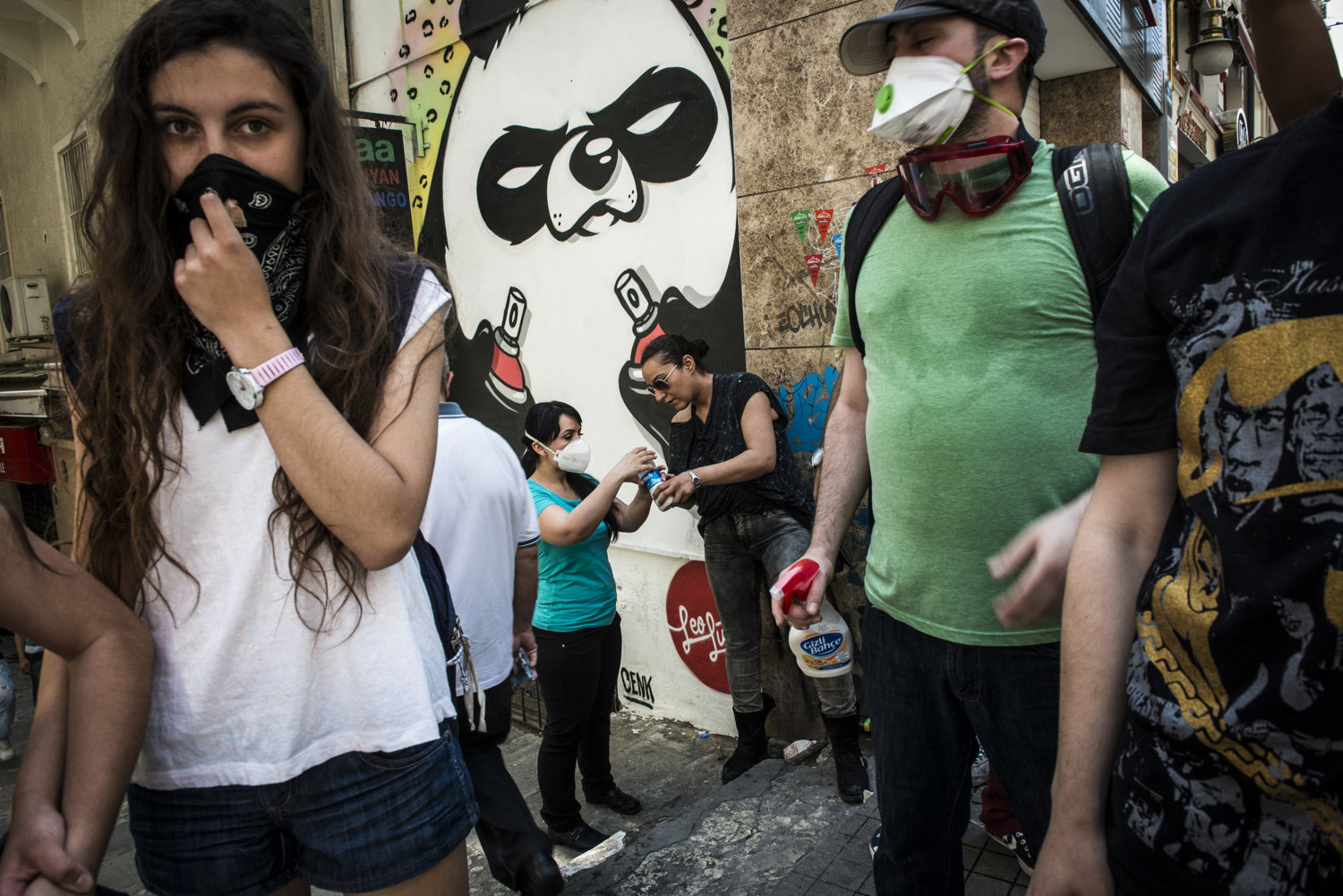  Students prepare a solution of water and milk as an a deterrent for the sting of tear gas off of Istiklal Cadessi on  June 1, 2013 