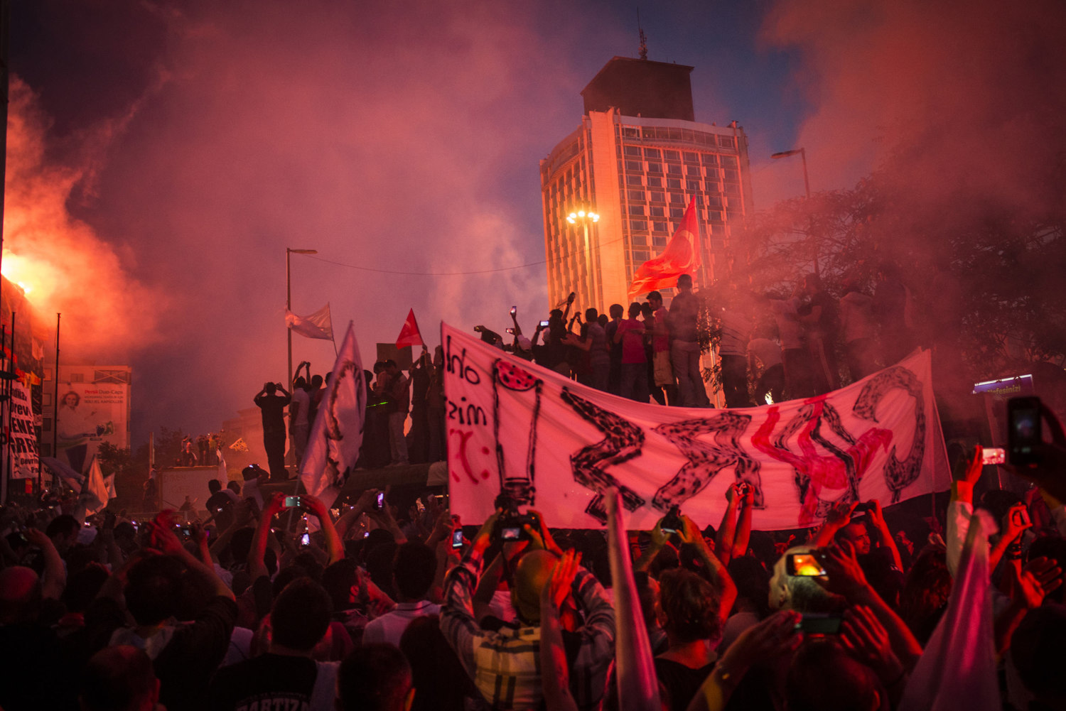  Fans merge in Taksim square, lighting flares and fireworks on June 8, 2013. Hundreds of thousands of football fans from the three major Istanbul teams march on Taksim's Gezi Park to protest the AKP party and its head Recep Tayyip Erdogan. 10 days of