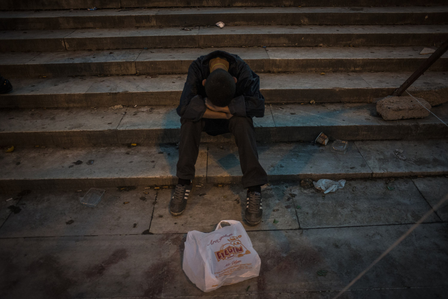  An exhausted boy falls asleep sitting up as protests in Istanbul continue on June 3, 2013 in Taksim Square. Istanbul, Turkey. 