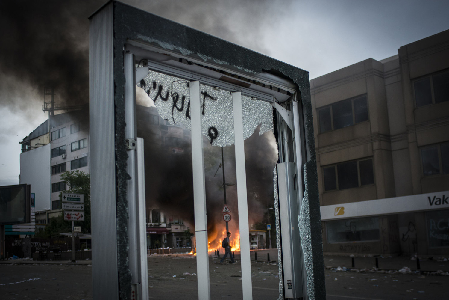  Men walk towards a burning car to put it out. Protests in Istanbul, Turkey continue early on the morning of June 2nd 2013. 