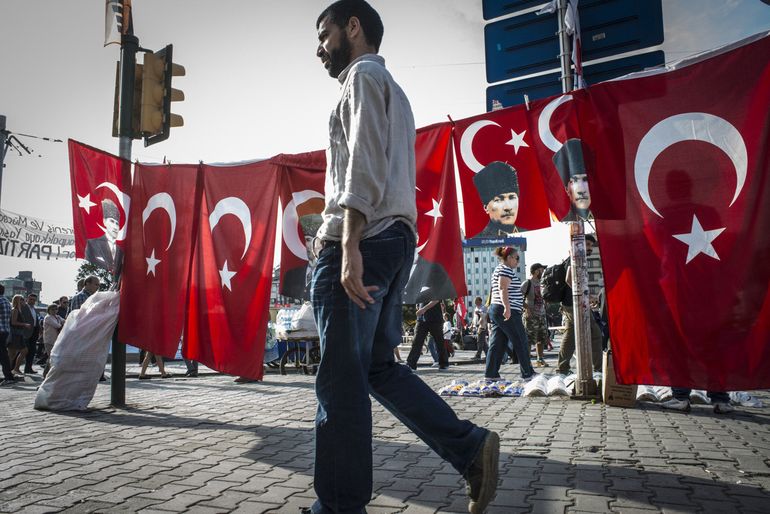  A man walks buy flags picturing the face of Ataturk, the founder of Modern Day Turkey on June 6, 2013. 