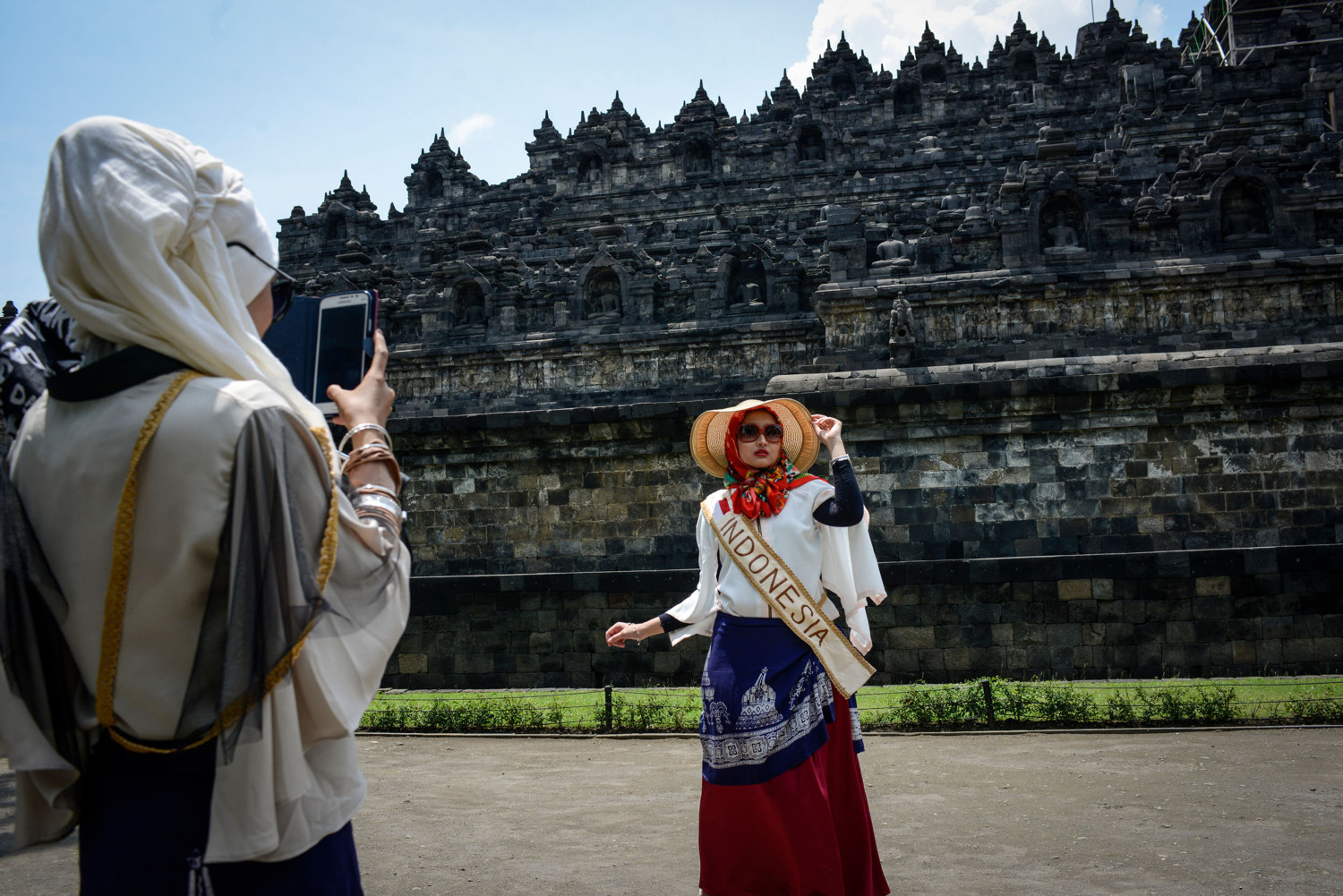  The Miss Muslimah Finalists take photos of themselves in front of Borobudur,  a 9th-century Mahayana Buddhist Temple outside of Yogakarta, Indonesia. 
 