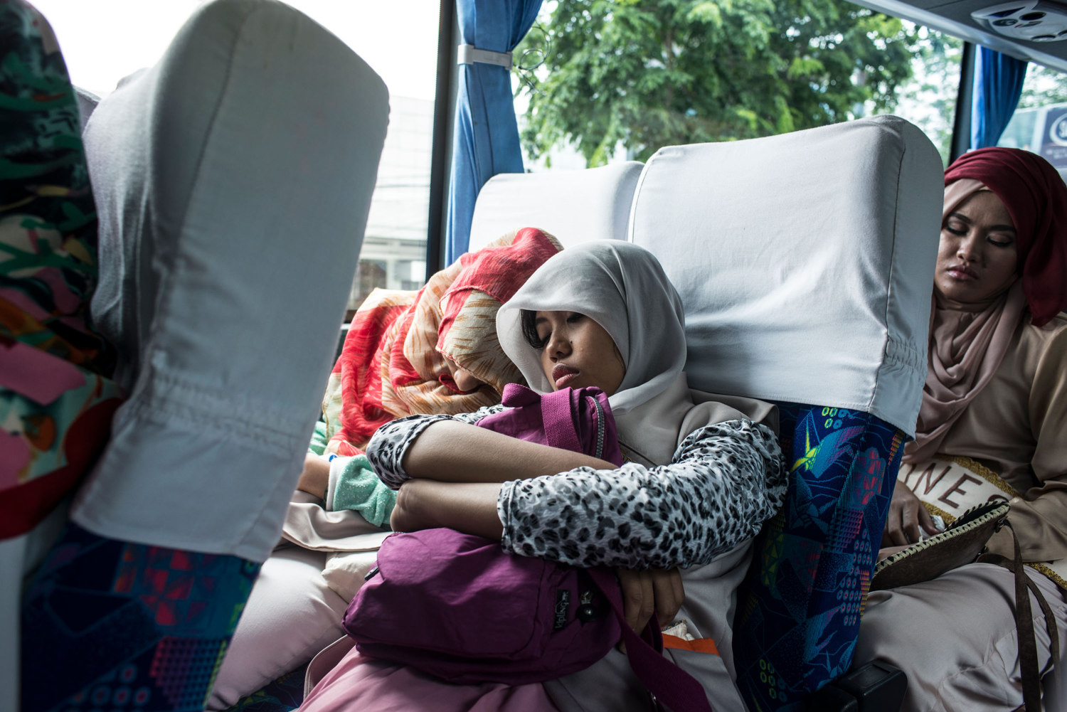  Two LO's or Logistic officers, who are each assigned to a girl as a defacto babysitter, sleep on the bus between events.  