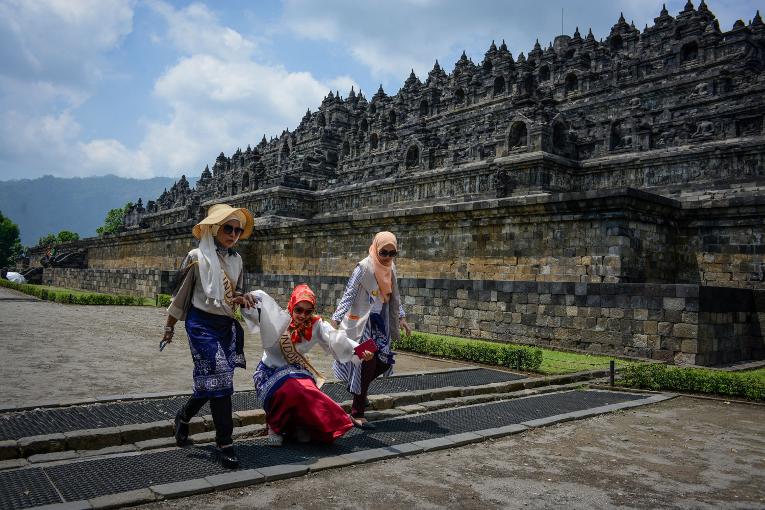  Two Indonesian finalists walk past Borobudur,  a 9th-century Mahayana Buddhist Temple outside of Yogakarta, Indonesia. 
 