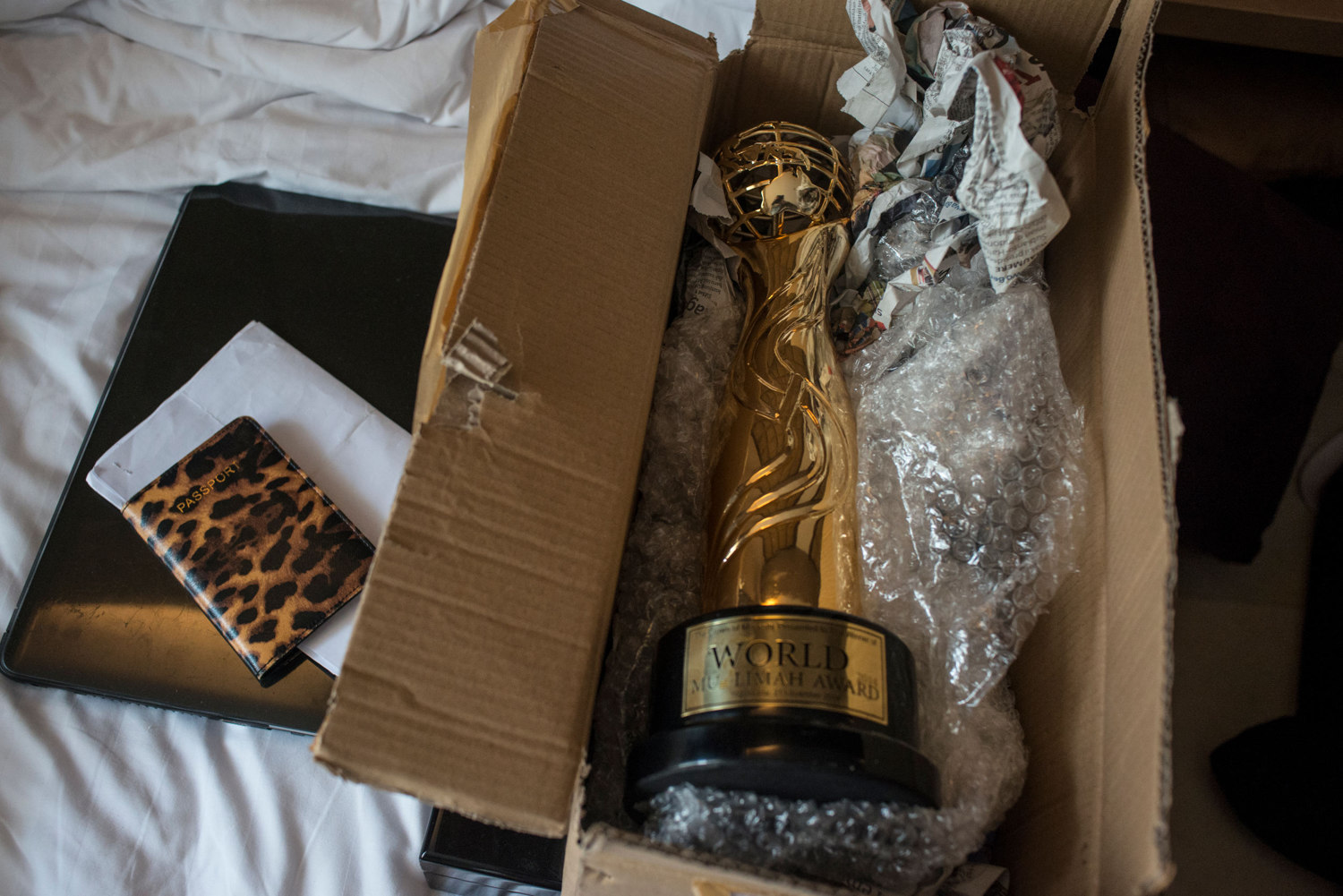 The Miss Muslimah 2014 trophy sits on Fatma Ben Guefrache of Tunisia's bed as she packs to leave Indonesia. 
 