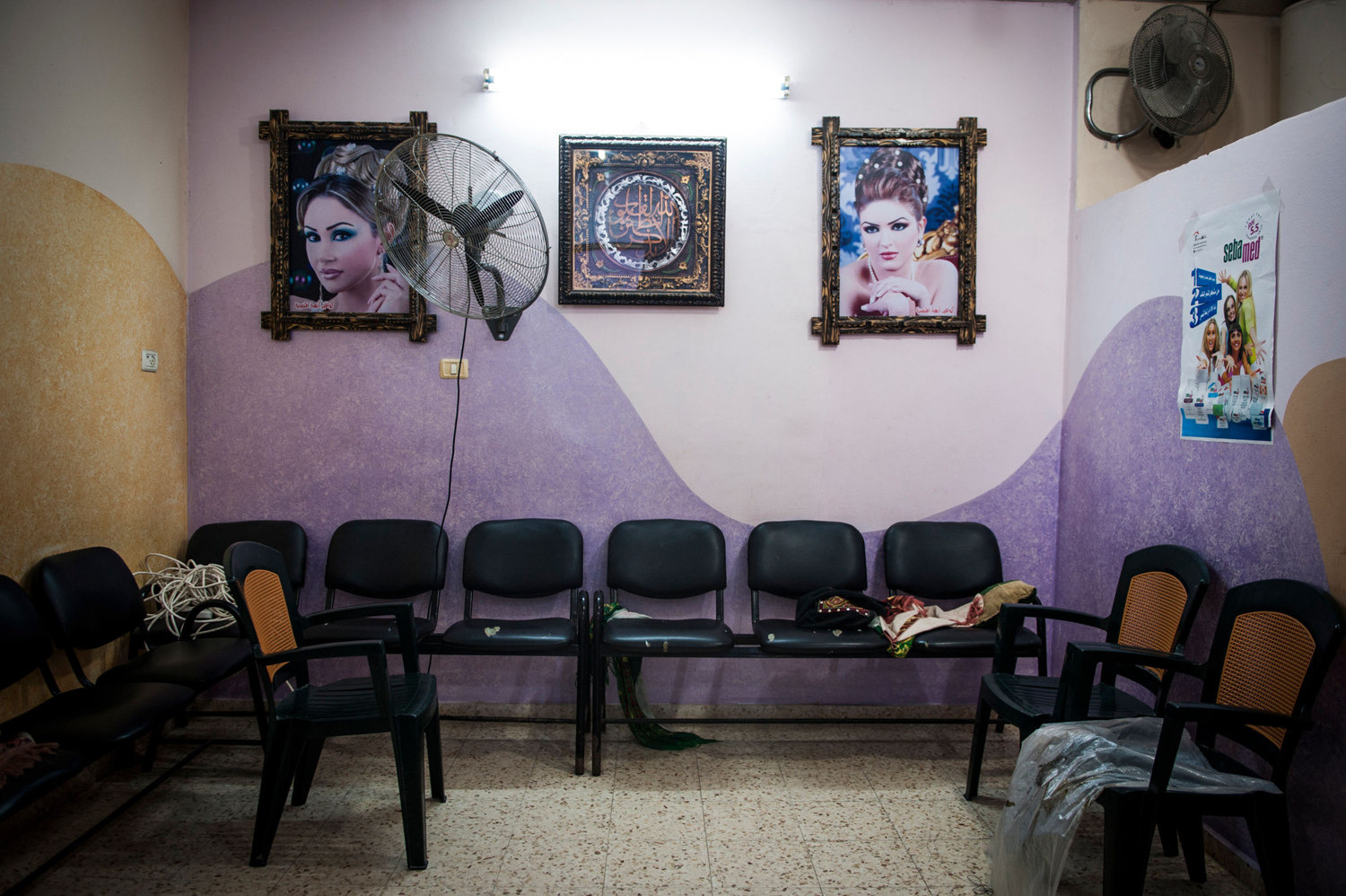  At a salon in Gaza City women come to get their hair, nails, and makeup done before weddings. In many families, a woman is not allowed to be seen without a veil by a man outside of her family, so beauty salons are for women only. 