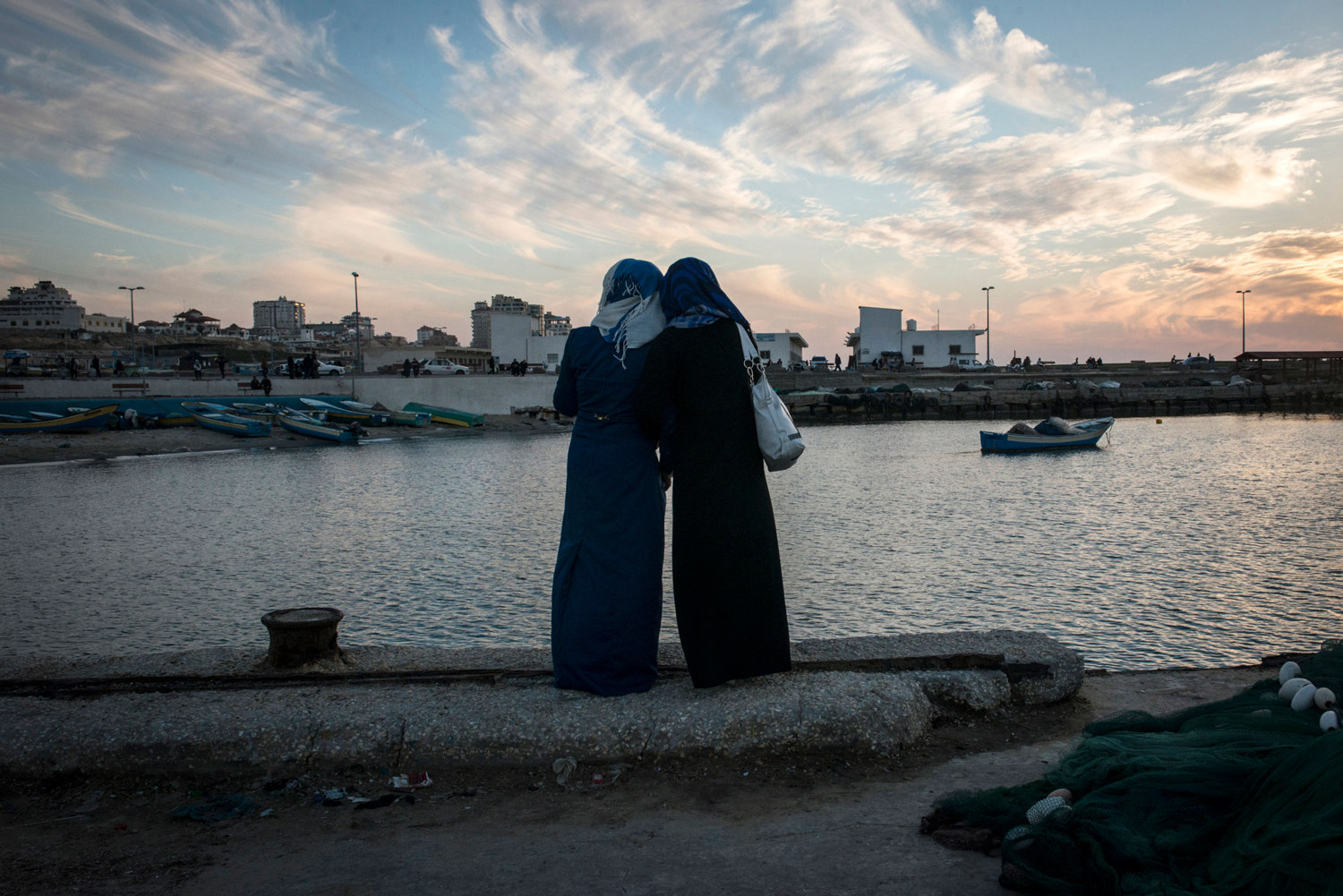  Girls watch the sun set at the harbor in Gaza City. While living in Gaza is undeniably tough, being a woman there is harder. 