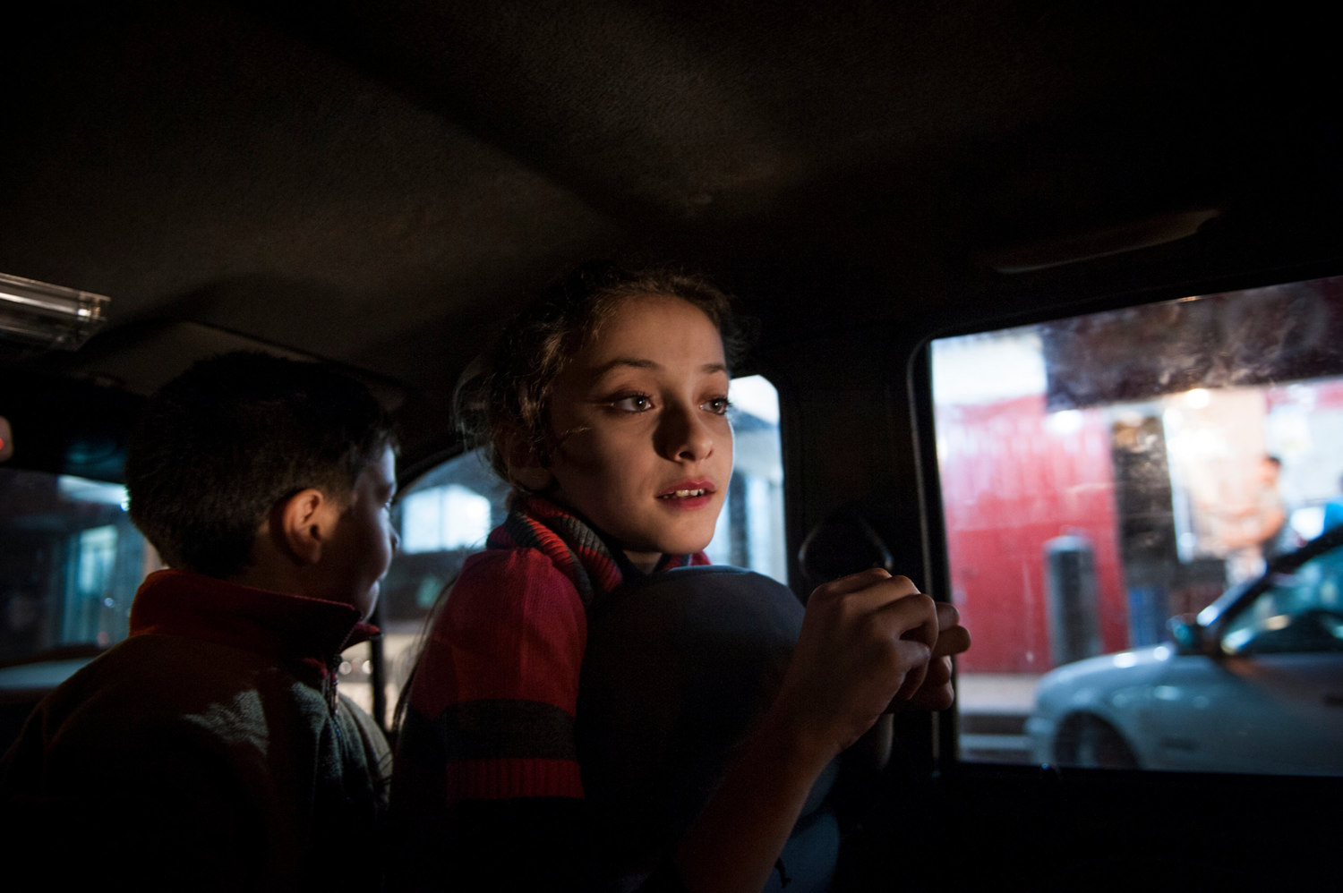  Yara and her brother waiting for their father to return with schwarma as an evening treat after a recent conflict ended. 