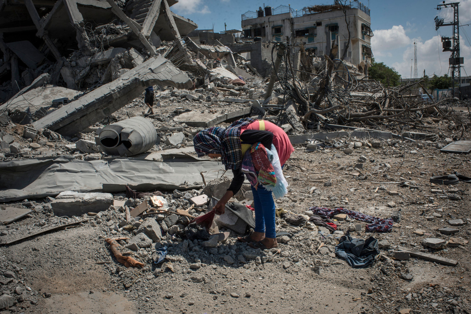  A girl picks through the rubble at what was previously her families home in Beit Hanoun, Gaza. 