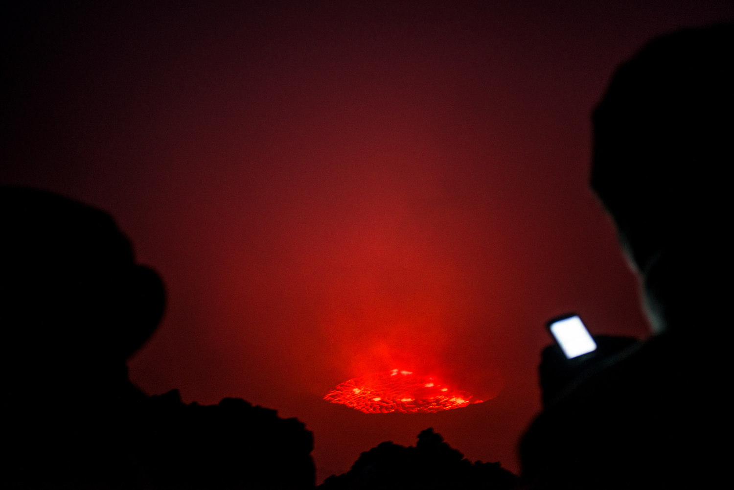  After dark, the lava lake is visable though the fog. Virunga is Africa's oldest national park and home to over 200 of the world's 800 remaining mountain gorillas. For two decades it has been at the centre of a war. Hundreds of rebels operate in the 