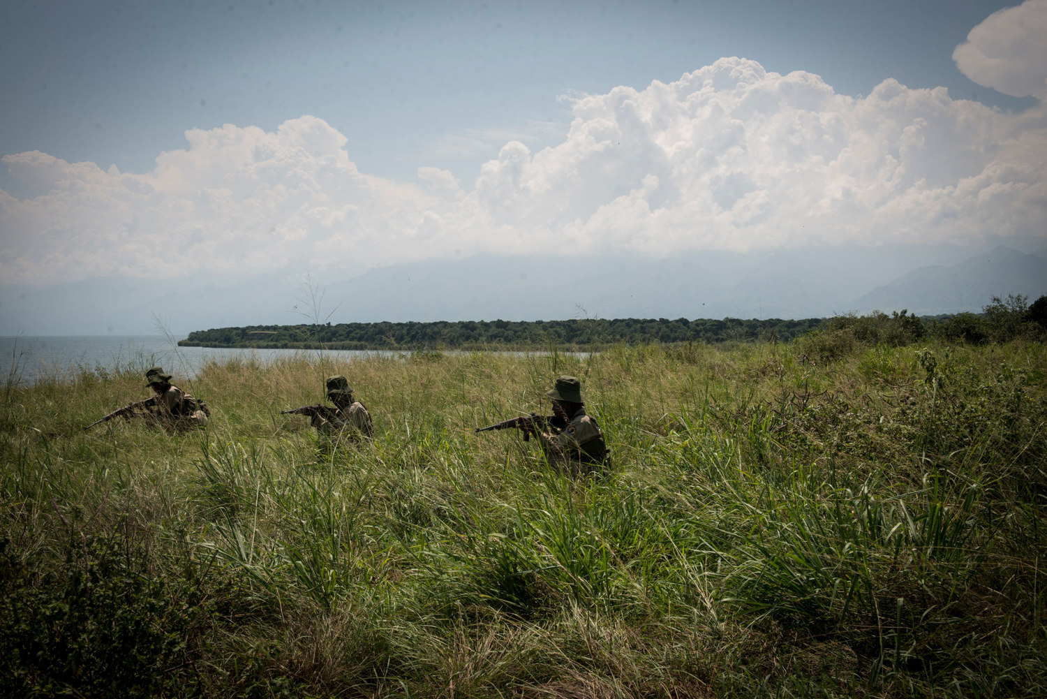  Rangers-in-Training rehearse military drills in the savannah. Virunga's park guards responsibilities eclipse those of a typical park guard as the area is known to have incidents with local rebel groups.
 