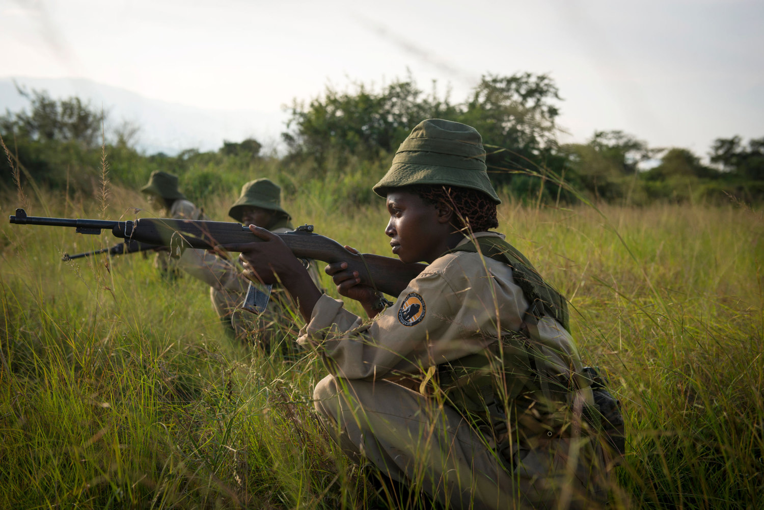  Rangers-in-Training during military style drills in the savannah. Patrols can last up to 6 hours in the scorching heat. Virunga's park guards responsibilities eclipse those of a typical park guard as the area is known to have incidents with local re