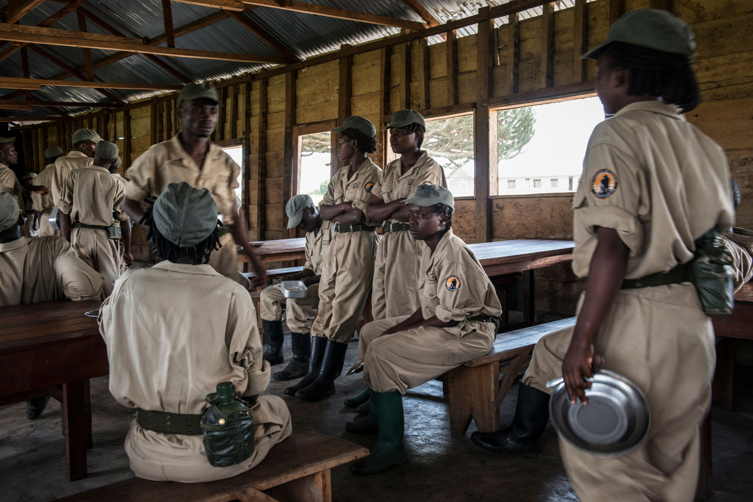  Female rangers wait before being served their meal of rice and beans, which they receive up to two times a day.
 
