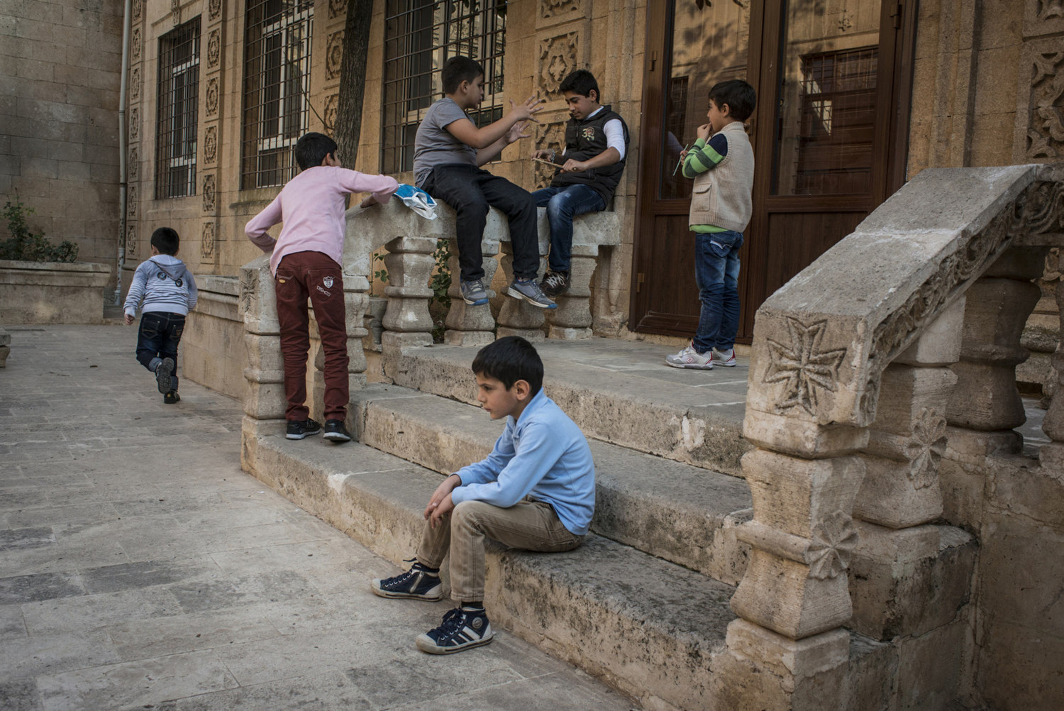  Assyrian boys play in the in the courtyard of Mor Barsaumo before an Aramaic lesson on October 30th, 2014.

The Mor Barsaumo church is over 1,500 years old and was renovated in 1943. It is located 21 Şen Caddessi in Midyat, Turkey. 