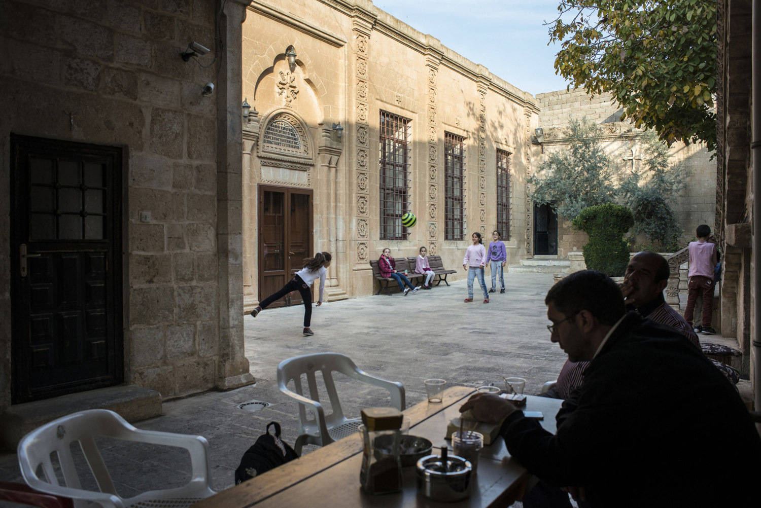  Decon Ayhan Gürkan,(l) reads from a religious book in the courtyard of Mor Barsaumo before teaching an Aramaic lesson on October 30th, 2014.

The Mor Barsaumo church is over 1,500 years old and was renovated in 1943. It is located 21 Şen Caddessi in