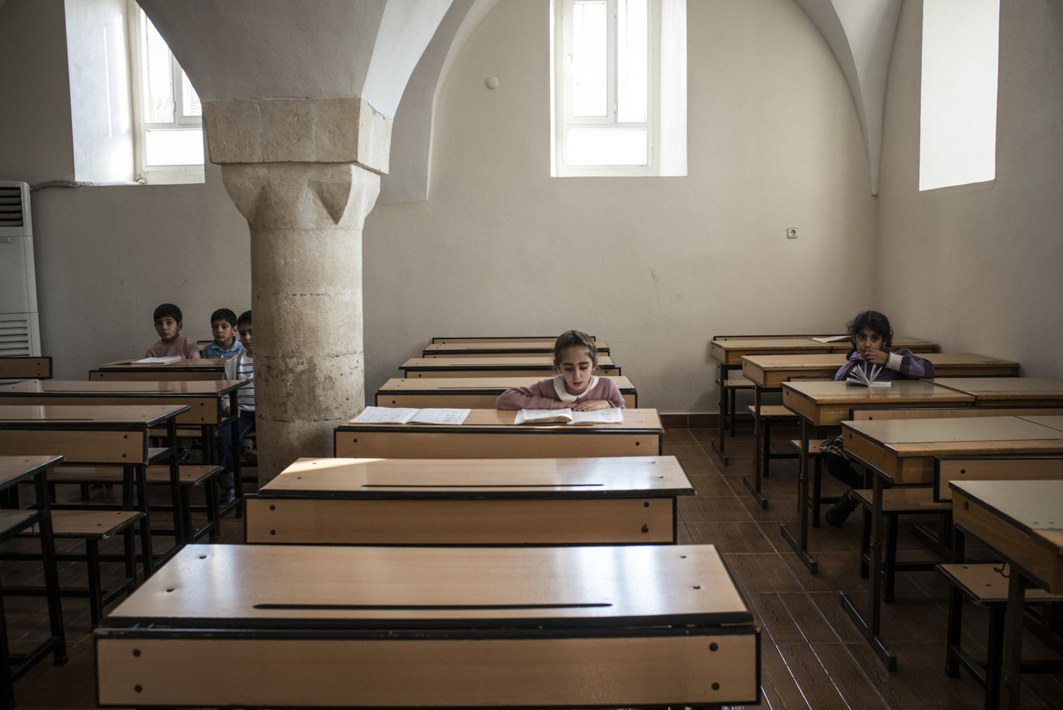  A girl reads during her Assyrian class in the classroom of Mor Barsaumo church on October 30th, 2014.

The Mor Barsaumo church is over 1,500 years old and was renovated in 1943. It is located 21 Şen Caddessi in Midyat, Turkey. 