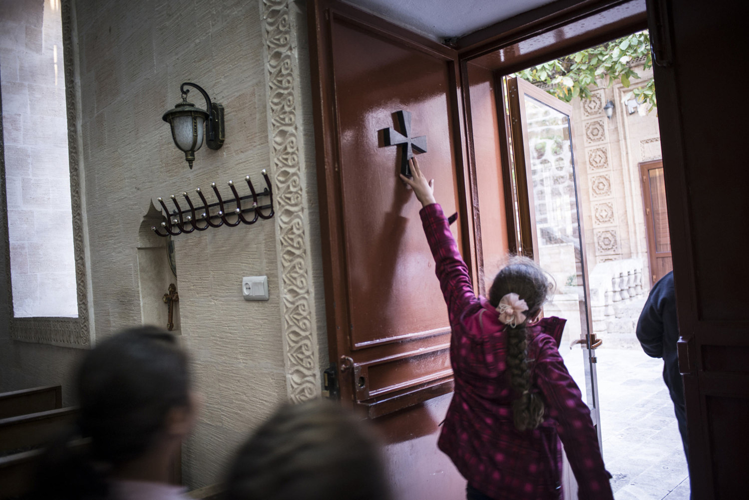  Members of the Asyrian community touch a cross on the door after praying at Mor Baraumo church during an afternoon service on October 30th, 2014.

The Mor Barsaumo church is over 1,500 years old and was renovated in 1943. It is located 21 Şen Caddes