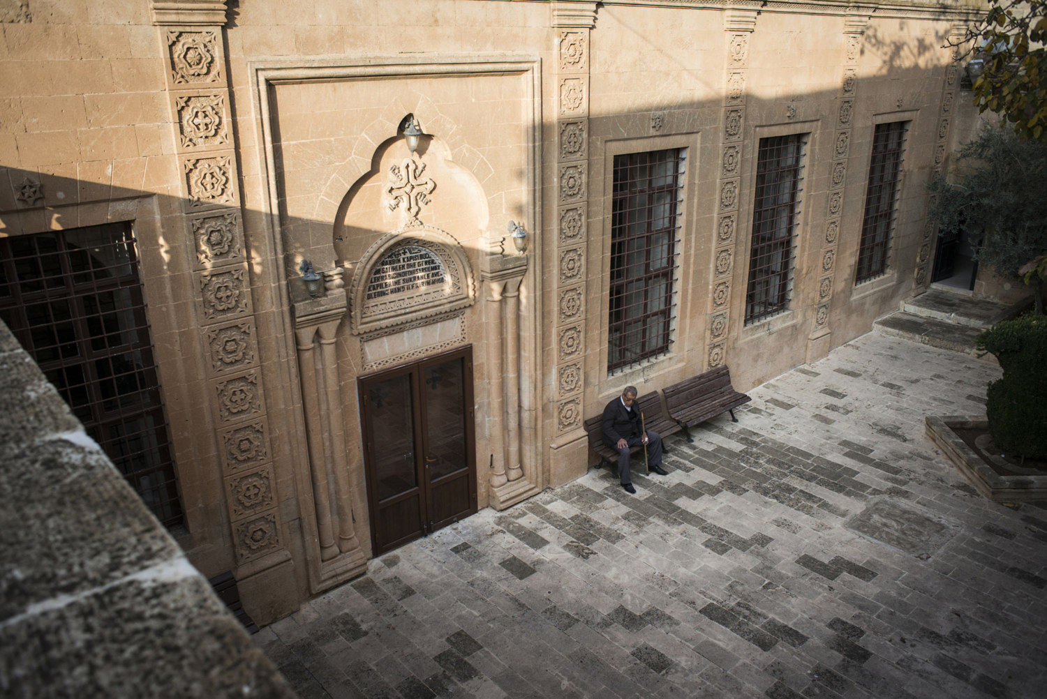  A man waits in the courtyard of Mor Barsaumo church on October 31th, 2014.

The Mor Barsaumo church is over 1,500 years old and was renovated in 1943. It is located 21 Şen Caddessi in Midyat, Turkey. 