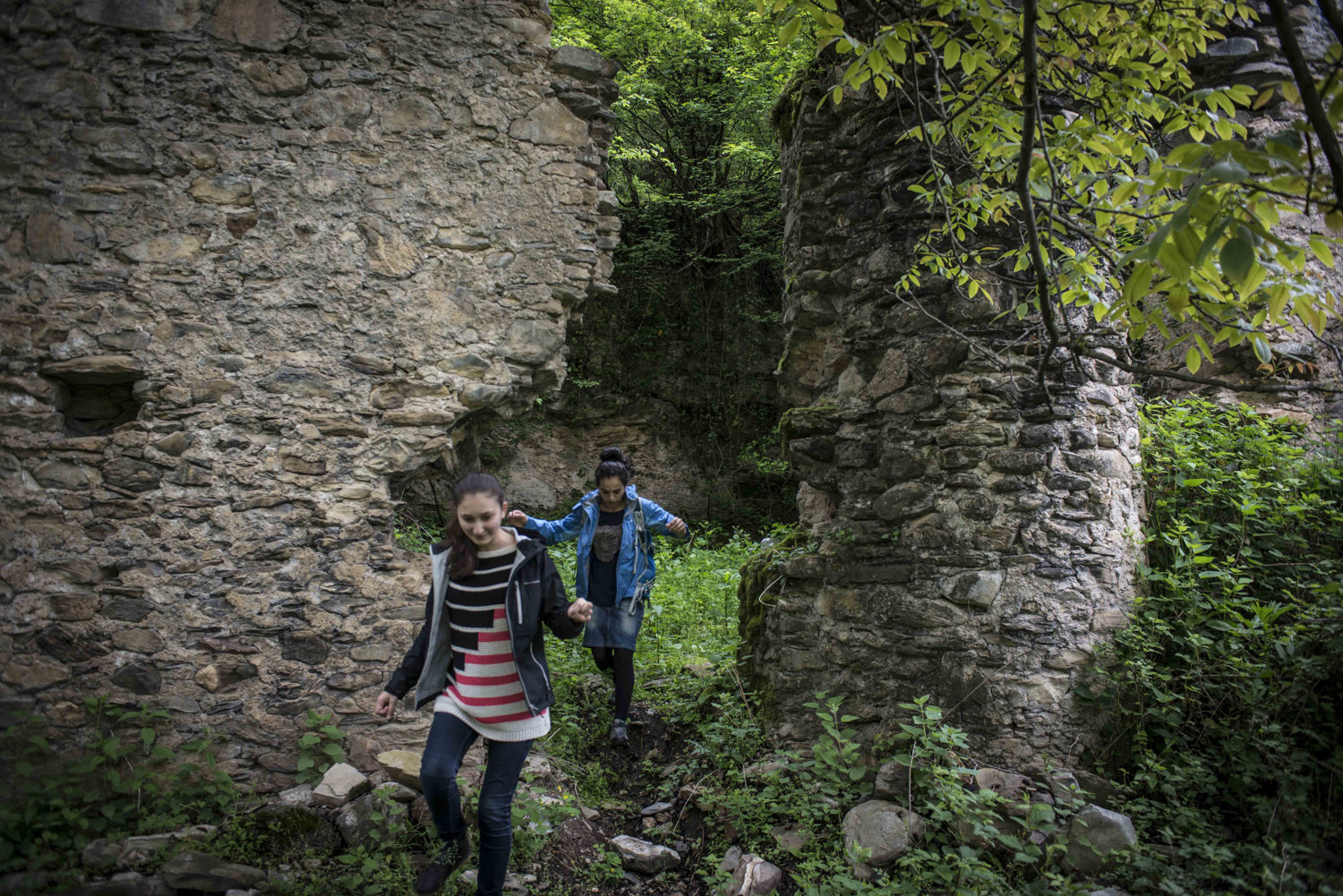  Two girls explore the remains of a Christian church.

 