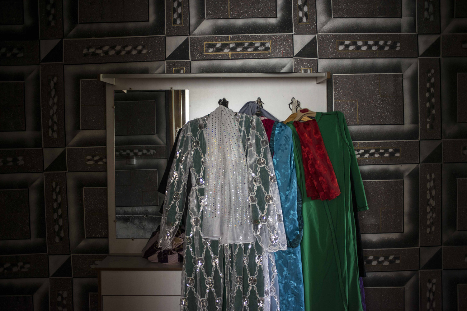  Traditional costumes hang in the home of one of the female Sufi leaders. The group has performed abroad, in countries diverse as Poland and Morocco.

 