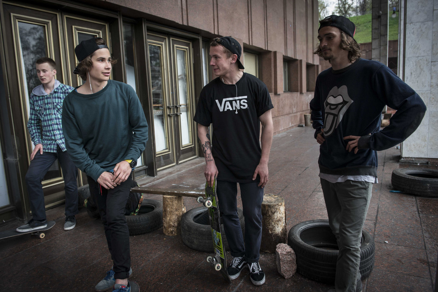  Boys and Tihon Poitiko, (center)  skate outside of a government building. This place was previously off limits to skaters before the revolution. 