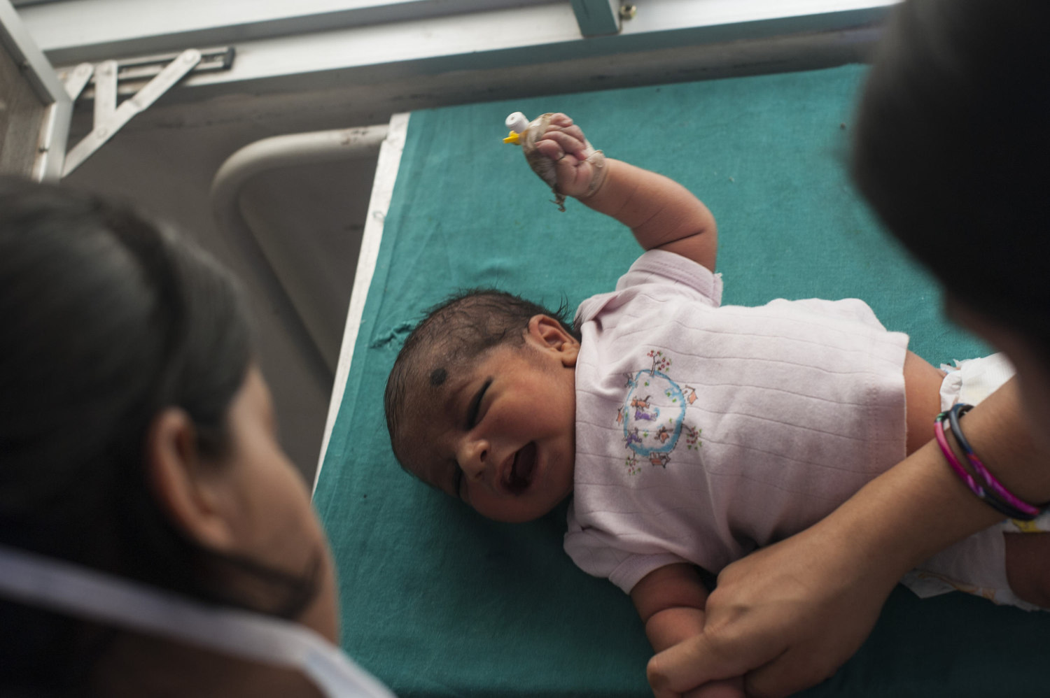  A nurse gives a shot to a baby boy at the Gurgaon Hospital outside of New Delhi, India, where- defying statistics more girls are born than boys.&nbsp; 
