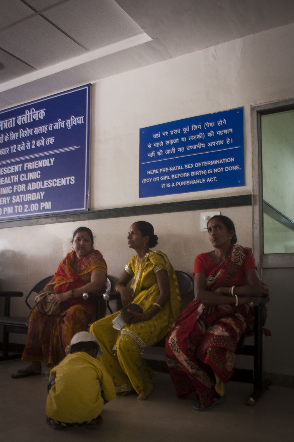  Woman in front of a sign declaring that ultrasounds to determine sex are illegal at the Gurgaon Hospital outside of New Delhi, India. 