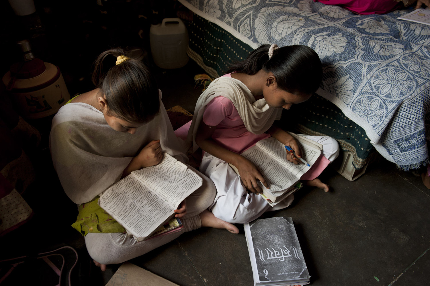  Girls practice reading at the Sadnha Institute Center in Mullahera- a make shift after school program run for the children of migrant workers there are about 100 kids taught in five shifts.  