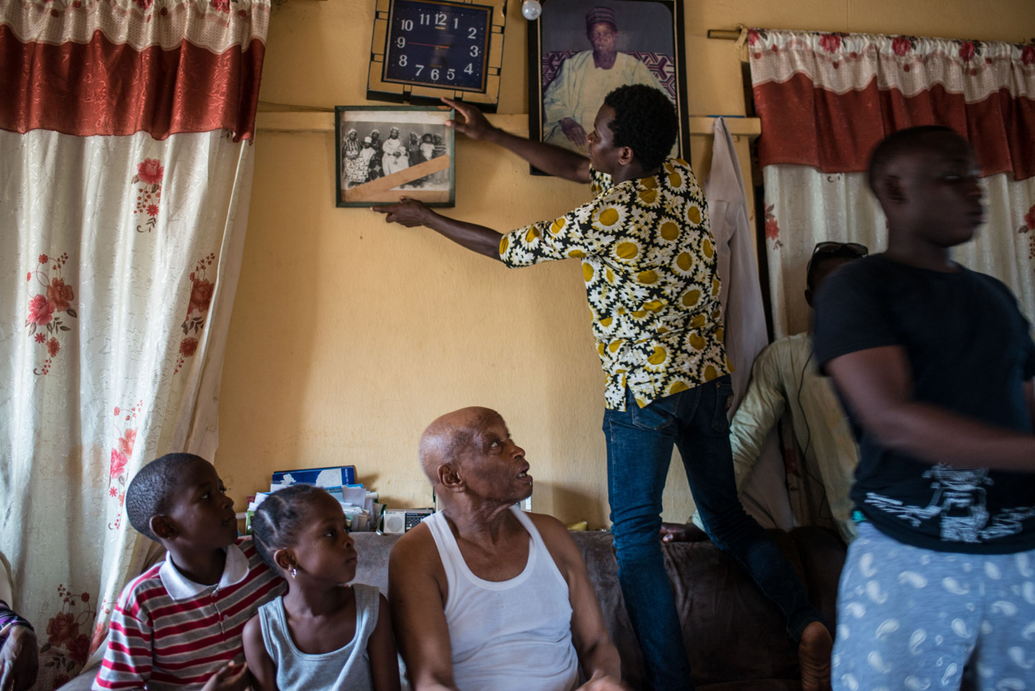  Ahmed Musa, a 93-year-old nut trader, asks his grand son to pull down a photo of him and his three wives. In his seven decades as the reigning nut trader in town, he has had 21 children by five wives, and 118 grandchildren. They call him Baka Son Ma